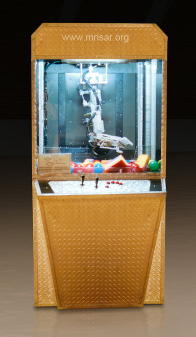 Robotic Exhibits; The early version (2001) of MRISAR's Top mounted 5 Finger Robotic Arm Exhibit. MRISAR has designed and fabricated the earth’s largest selection of world-class, public use, interactive robotic exhibits.