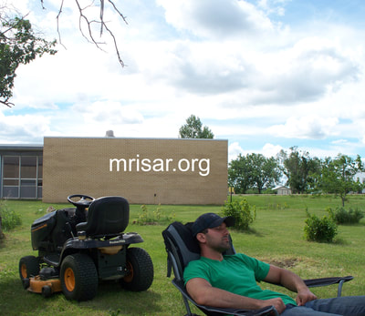 Michael Cook taking a break. During the first 3 years after relocating, MRISAR’s Team hand-planted over 4,000 edible and medicinal trees and shrubs on the 10 acre grounds at our North Dakota Complex.