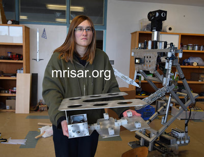 MRISAR Team member Aurora Siegel holding one of our larger Mars Probe Rovers in its early stage of fabrication!