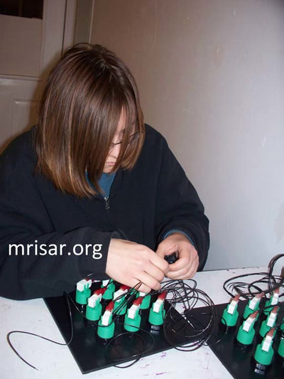 MRISAR's Team member Aurora Siegel fabricating Robotic Arm exhibits.