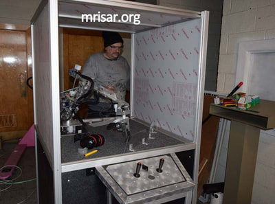 MRISAR's Team members installing our base mounted 3 Finger Robotic Arms into the exhibit cases we made. We have been making exhibit robotics since 1991.