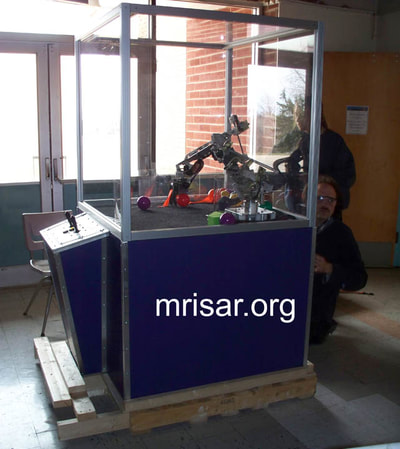 MRISAR's Team members installing our base mounted 3 Finger Robotic Arms into the exhibit cases we made. We have been making exhibit robotics since 1991.