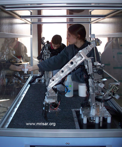 MRISAR Team members Autumn and Aurora Siegel fabricating Robotic exhibits. They are the youngest members of the MRISAR team and began their apprenticeship as preschoolers. 
