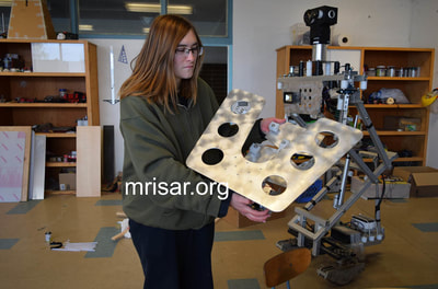 MRISAR Team member Aurora Siegel holding one of our larger Mars Probe Rovers in its early stage of fabrication!
