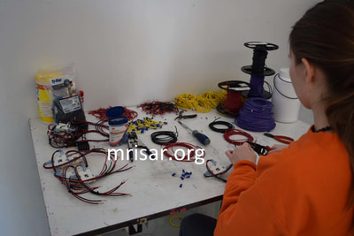 MRISAR's Team member Autumn Siegel fabricating Robotic Arm exhibits.