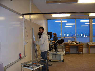 MRISAR's Team member Autumn Siegel and Michael Cook fabricating Robotic Arm exhibits.