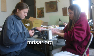 MRISAR’s team members Autumn and Aurora Siegel in 2009, assembling custom power supplies for our interactive regular and Telepresence exhibit grade 5 and 3 Finger Robot Arms! We sell them as kits, or as a complete exhibit, in our standard cases or in a custom case. We have been making exhibit robotics since 1991.