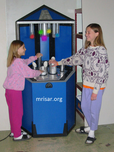 Science Exhibit; MRISAR's team members Aurora & Autumn Siegel testing a Photonic Spectrum exhibit. They have been making them since 2001.