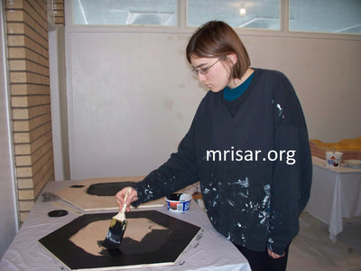 Interactive Science Exhibit; Mini Touch Spectrum, designed and fabricated by MRISAR. Seen here is MRISAR Team member Aurora Siegel, who began her apprenticeship in science, art and robotic exhibit creation as a preschooler. We made our first version in 1985.