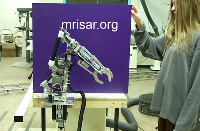 MRISAR’s team member Autumn Siegel seen here during the testing of a custom ordered miniature exhibit grade 5 finger Robot Arm kit! We sell them as kits, or as a complete exhibit, in our standard cases or in a custom case. We have been making exhibit robotics since 1991.