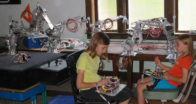 MRISAR’s team members Autumn and Aurora Siegel in 2003, assembling control panels for our interactive regular and Telepresence exhibit grade 5 and 3 Finger Robot Arms! We sell them as kits, or as a complete exhibit, in our standard cases or in a custom case. We have been making exhibit robotics since 1991.
