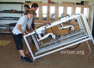 MRISAR's team breaking down Dual Challenge the Robot exhibits for ease of shipping.