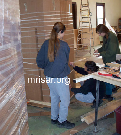 MRISAR Team members Autumn Siegel, Victoria Croasdell Siegel and Aurora Siegel, prepping for shipping our Robotic Arm exhibits.