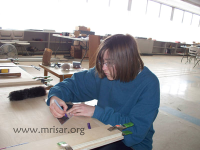 MRISAR's Team member Aurora Siegel fabricating Robotic Arm exhibits.