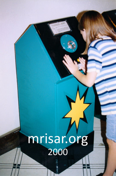 Interactive Science Exhibit; This is an older version of our Kaleidoscopic Viewer exhibit (2001), that was designed and fabricated by MRISAR. Seen here is MRISAR Team member Autumn Siegel, who began her apprenticeship in science, art and robotic exhibit creation as a preschooler. 