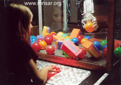 MRISAR's R&D Team member Autumn with our prototype Top Mounted Robot Arm Simulator in 2001.