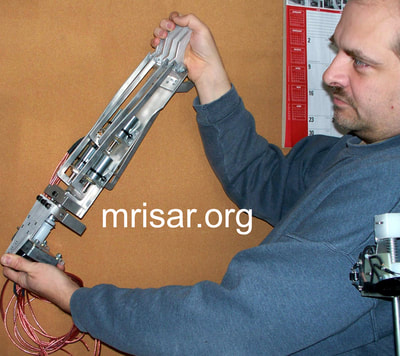 Robotic Exhibits; John Siegel fabricating MRISAR's Top mounted 5 Finger Robotic Arm Exhibit. MRISAR has designed and fabricated the earth’s largest selection of world-class, public use, interactive robotic exhibits.