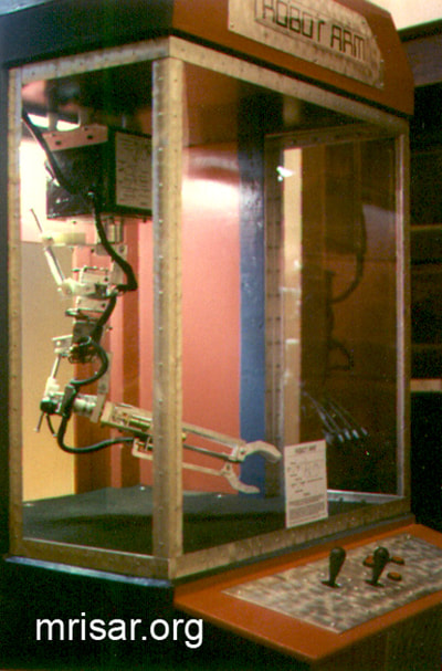 Robotic Exhibits; The early version (2001) of MRISAR's Top mounted 5 Finger Robotic Arm Exhibit. MRISAR has designed and fabricated the earth’s largest selection of world-class, public use, interactive robotic exhibits.