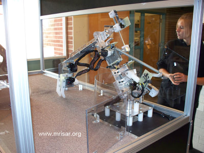 MRISAR R&D Team member Autumn with our Dual 3 Finger Robotic Arm Exhibit prior to shipping.